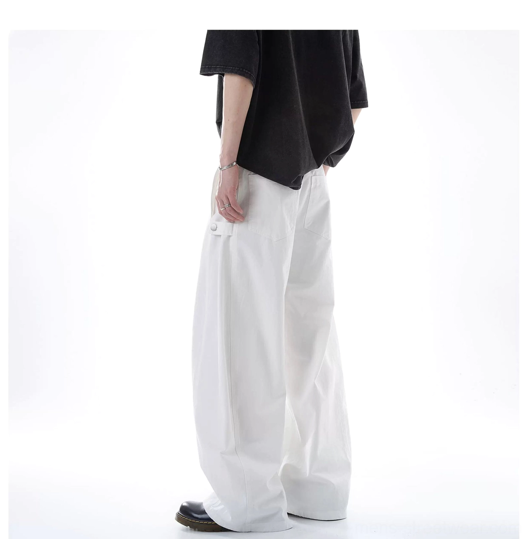 White ultra wide-leg cotton cargo pants shown from the side with oversized flowing legs, relaxed waist fit, crisp fabric, and a visible functional cargo pocket
