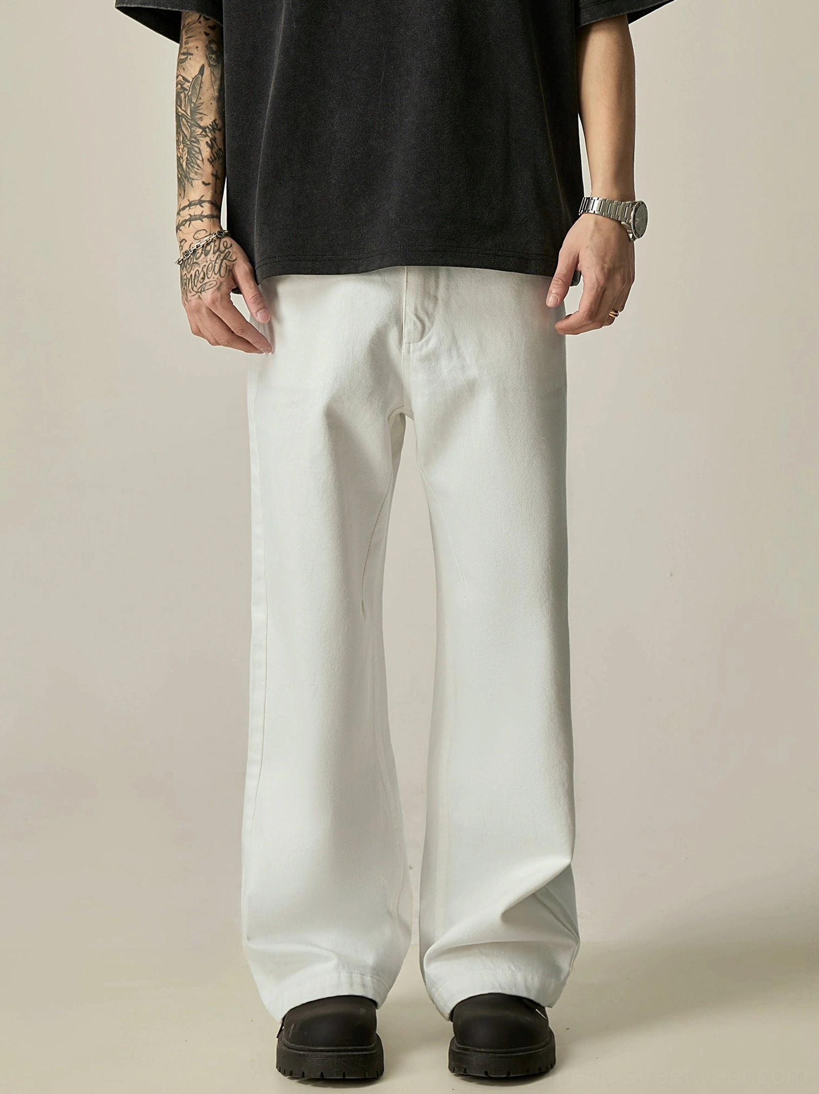 White ultra-wide leg cotton jeans front view styled with black oversized t-shirt and loafers for Seoul streetwear
