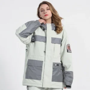 White unisex reflective color block ski jacket front three-quarter view showing gray hood trim, cargo pockets and sleeve patches