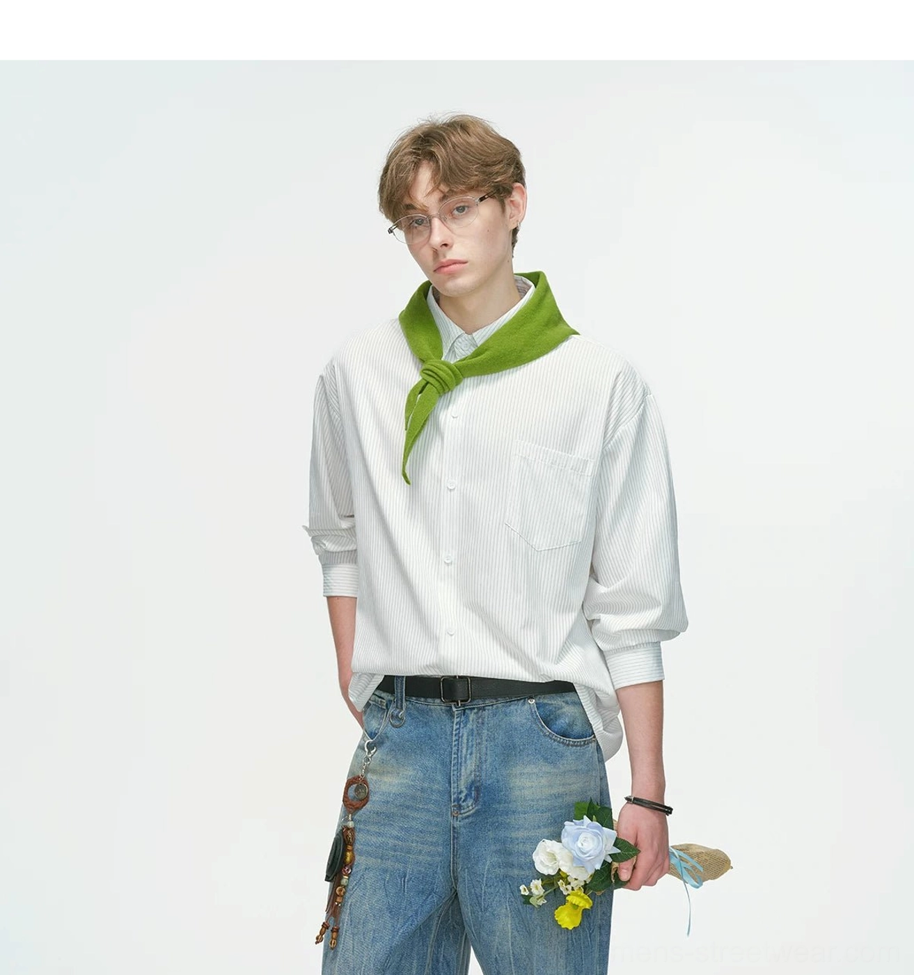 Waist-up view of a white vertical stripe overshirt with button front, chest patch pocket, green knotted scarf, and black bracelet