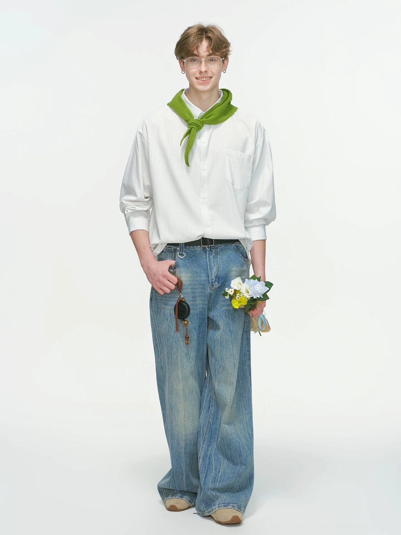White vertical stripe oversized streetwear overshirt with pointed collar and chest pocket styled with wide-leg blue jeans and a green neck scarf