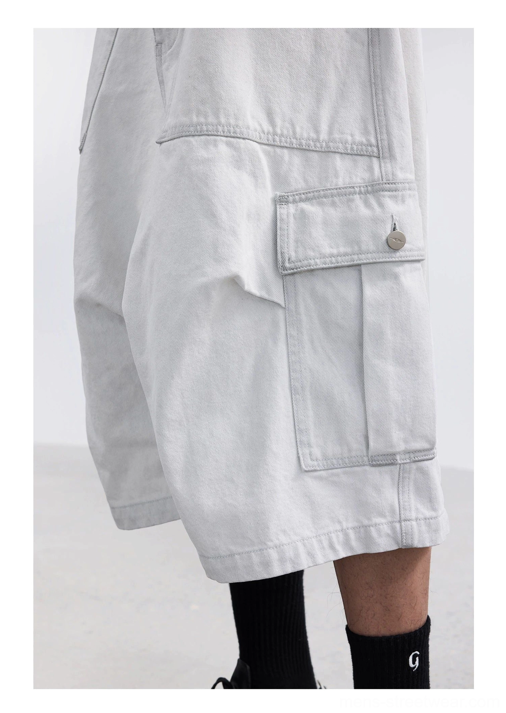 White washed denim wide-leg cargo capri shorts side detail with metal button flap pocket topstitching and oversized streetwear silhouette