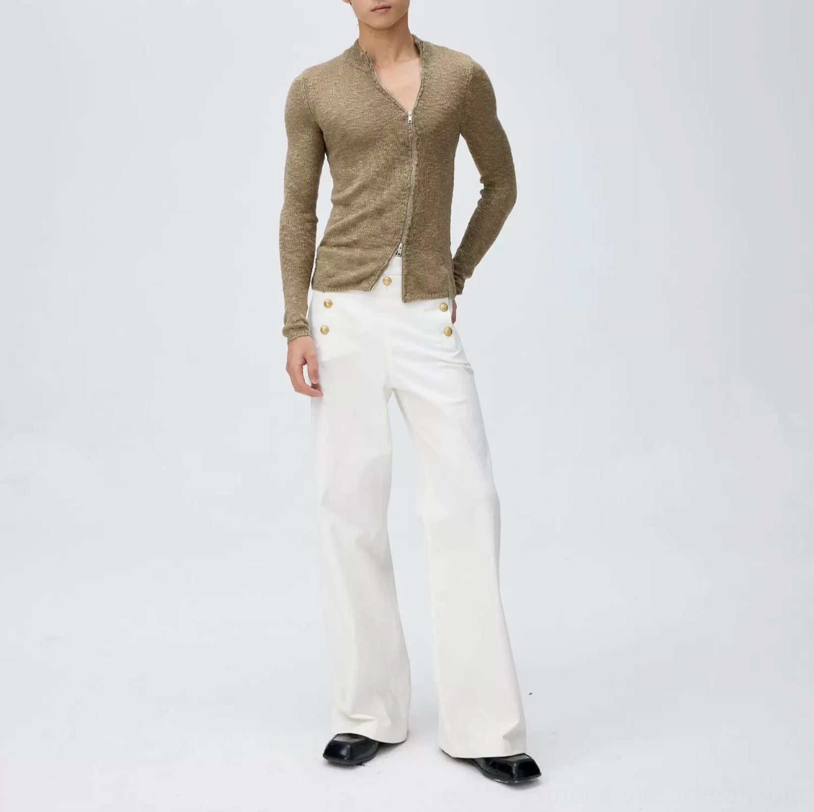 Front view of crisp white wide-leg sailor trousers with gold-tone double row buttons styled with a brown half-zip knit sweater