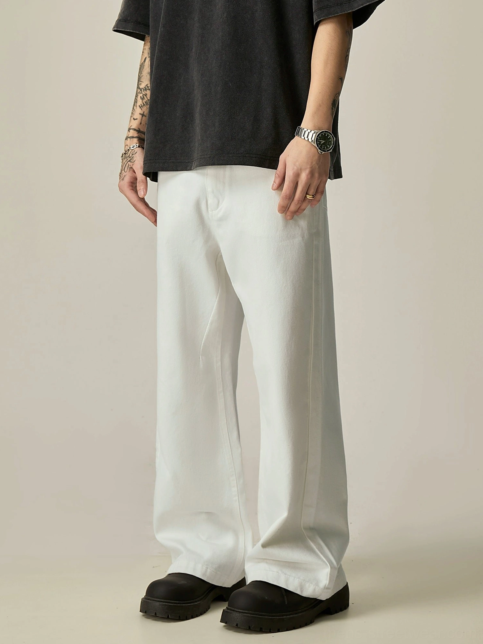 White wide-leg streetwear jeans three-quarter front view with relaxed fit and front pocket detail