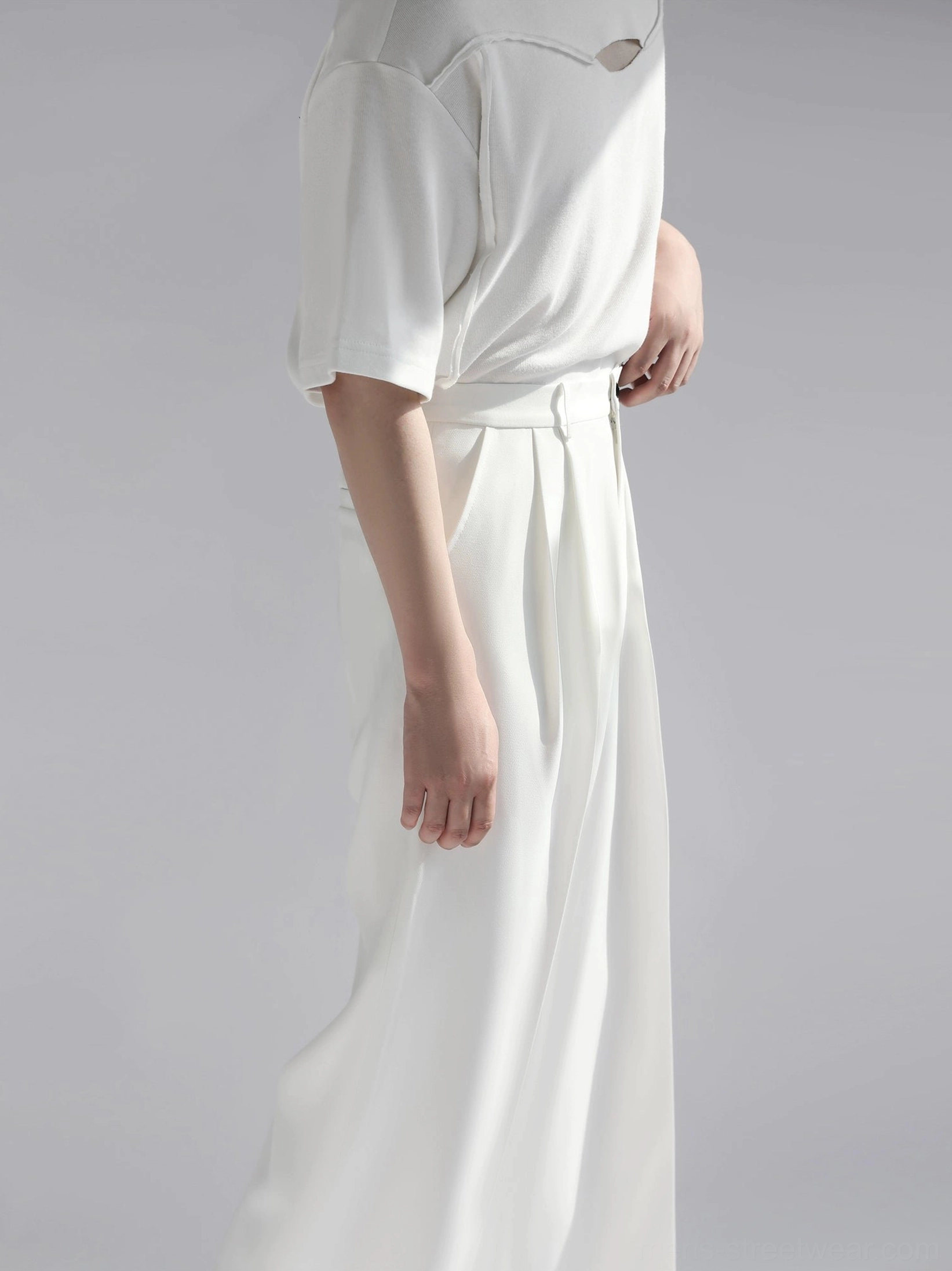 White wide leg tailored streetwear pants side close view showing high waist belt loops and front pleats