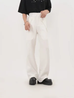 White wide-leg workwear trousers with high waist and prominent front pocket detailing shown in a minimalist studio fashion image