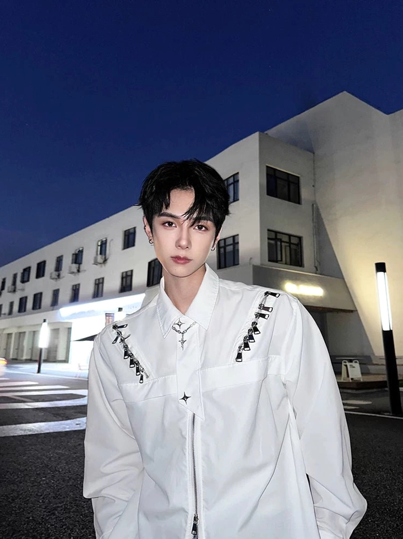White Korean streetwear shirt jacket with full front zipper and cross pendant detail at night