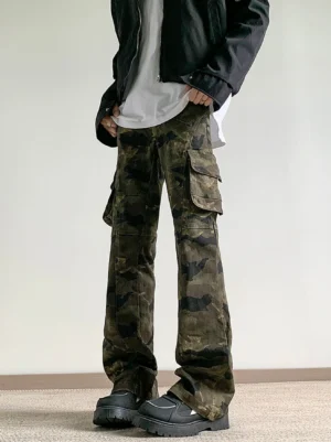 Front low angle view of dark green camouflage wide-leg cargo pants styled with a black jacket white shirt and chunky black work shoes in a Korean streetwear outfit