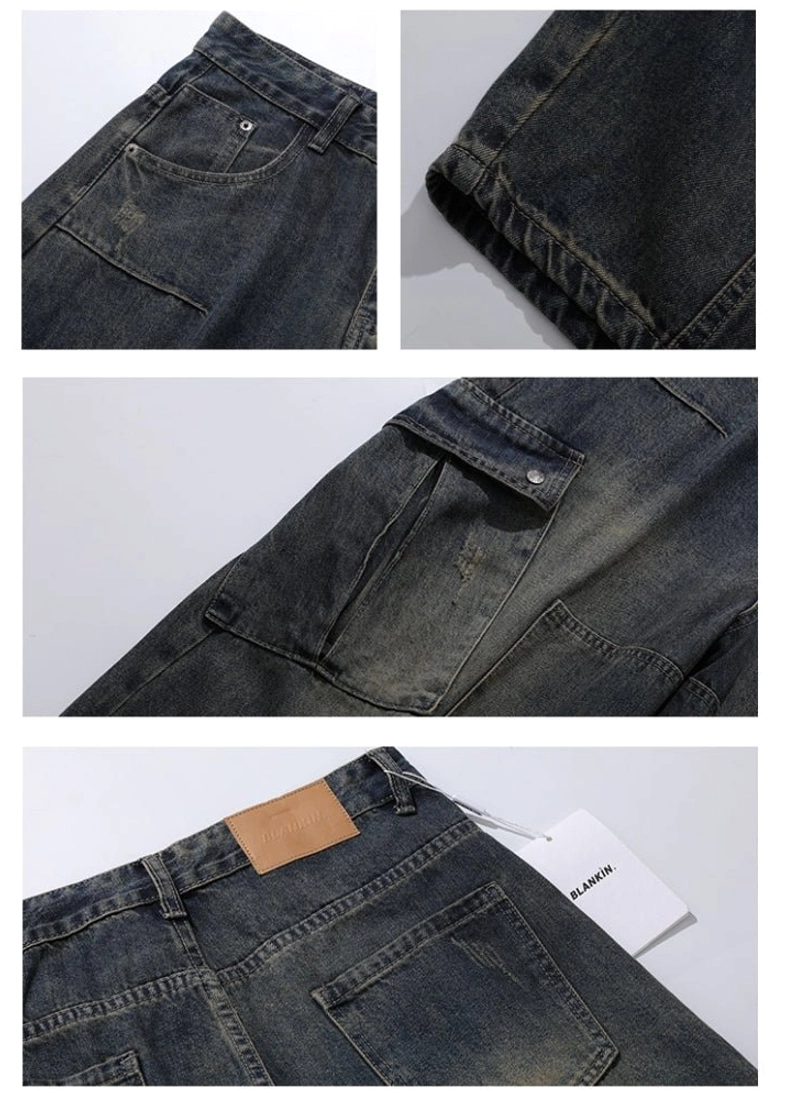 Close-up detail of riveted cargo pocket, visible denim stitching, raw fabric edge, and distressed vintage wash on wide-leg cargo jeans