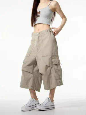Front view of khaki wide-leg cargo shorts with oversized cropped silhouette and side flap pockets styled for Korean streetwear