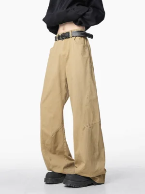 Khaki wide-leg carpenter jeans with curved leg seams styled on a model in a clean studio