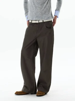 Three-quarter front view of smoky brown gray wide-leg chino trousers with slim gray sweater white belt and brown loafers