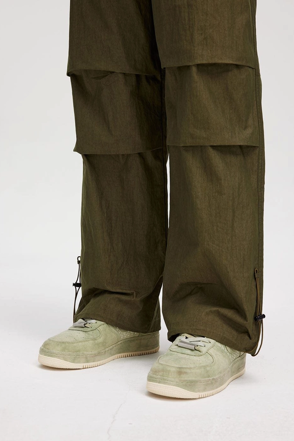 Wide-leg drawstring track pants product image showing relaxed utility styling and contemporary streetwear silhouette