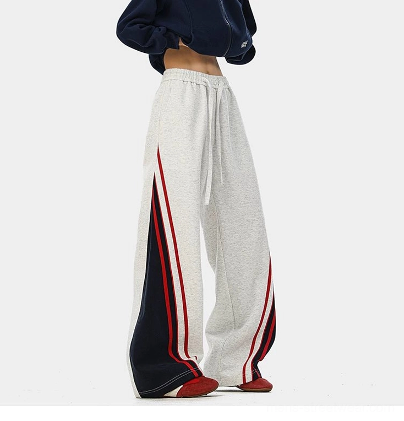 Wide-leg Korean streetwear track pants with varsity color blocking, drawstring waist, and comfortable cotton blend fabric