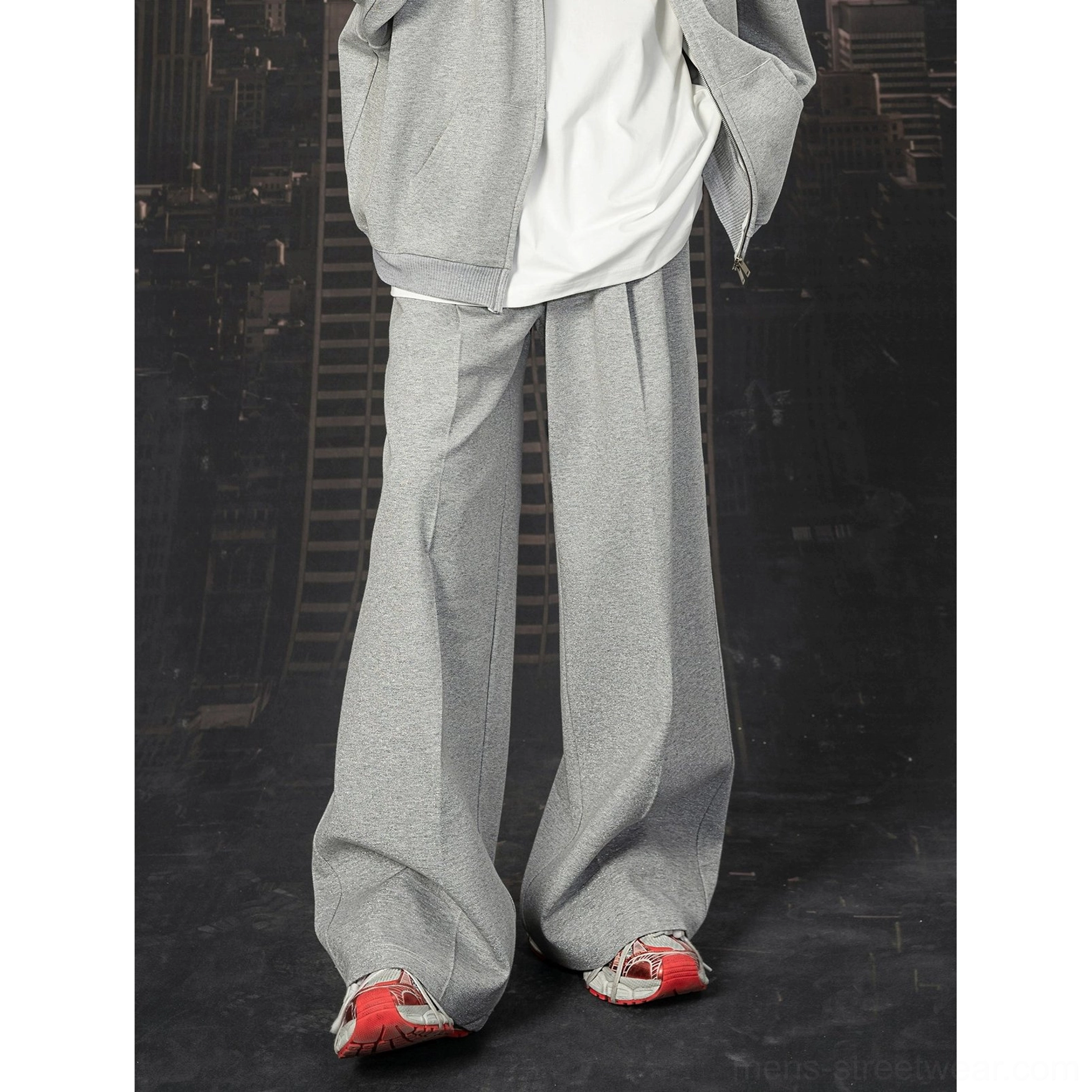 Close front view of wide-leg light grey sweatpants with textured sweatshirt fabric and layered hoodie styling