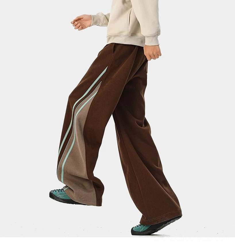 Wide-leg varsity track pants with contrast side stripes and relaxed Korean streetwear silhouette