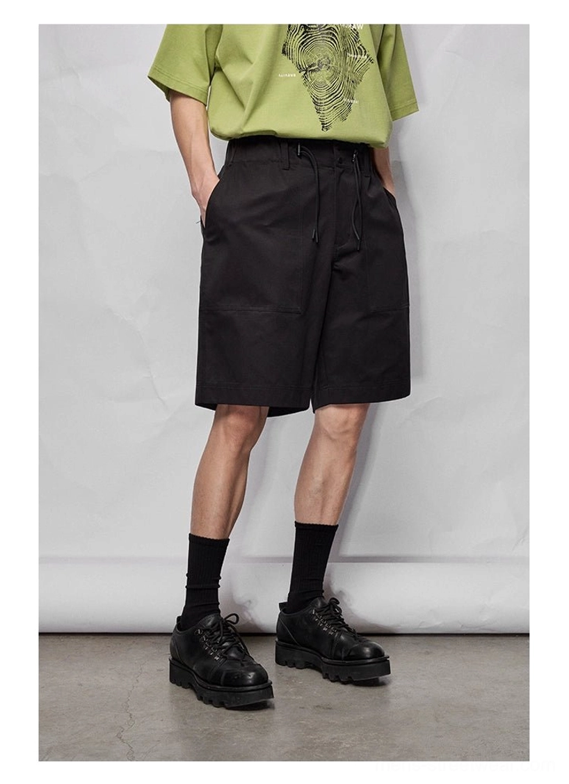 Relaxed streetwear bottoms featuring wide legs, practical pockets, and a flexible double-drawstring waist