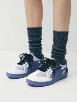 Model wearing wisteria purple bow-lace retro court sneakers with thick grey ribbed socks overhead view