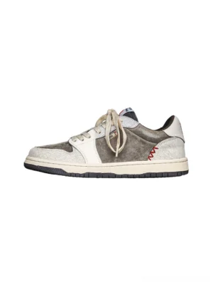 Worn-in suede leather sneakers in white brown and ash gray shown in a clean side profile on a white background