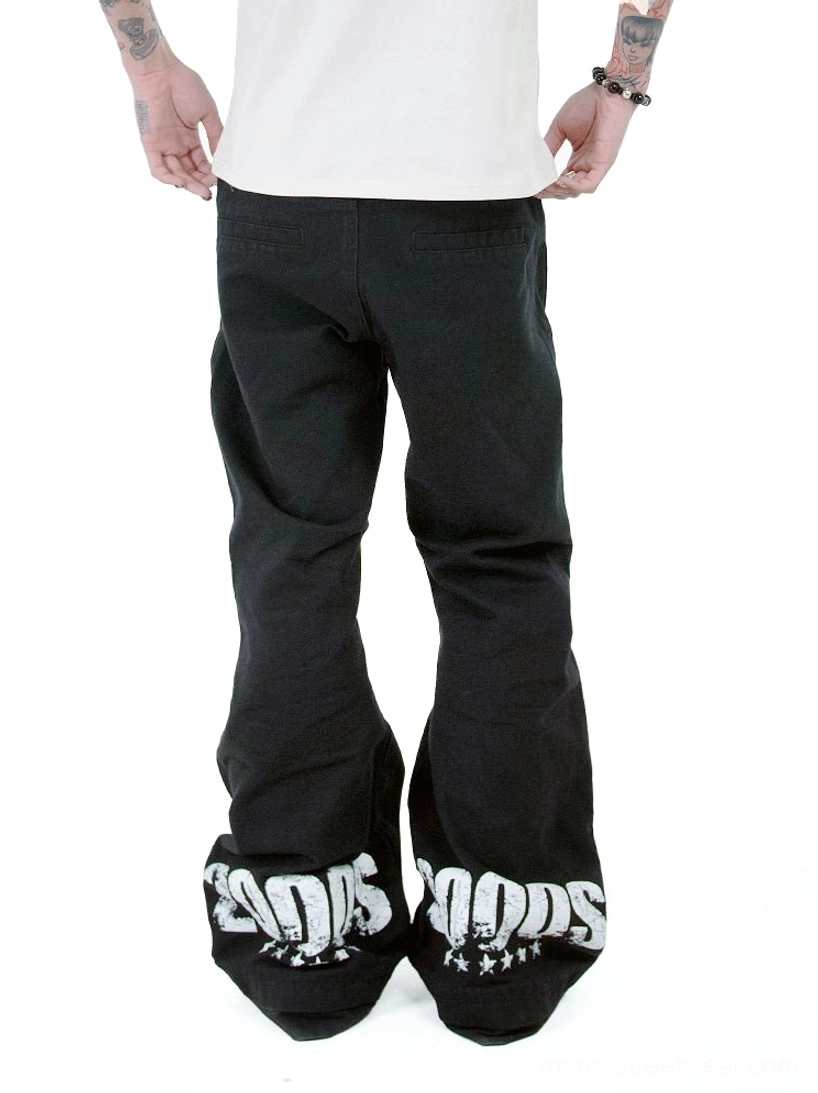 Rear full view of black Y2K 2000s graphic flare jeans showing bold white 2000S prints and star details on the wide hems