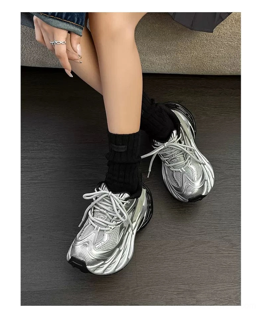 Y2K-inspired metallic platform sneakers with layered synthetic overlays and futuristic chunky runner shape