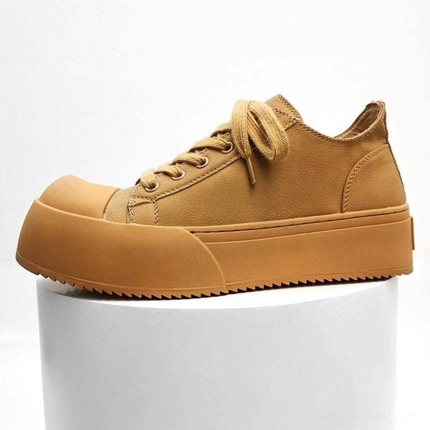 Chunky platform low-top streetwear sneakers available in a bold yellow colorway with leather upper, thick rubber sole, and retro court-inspired design