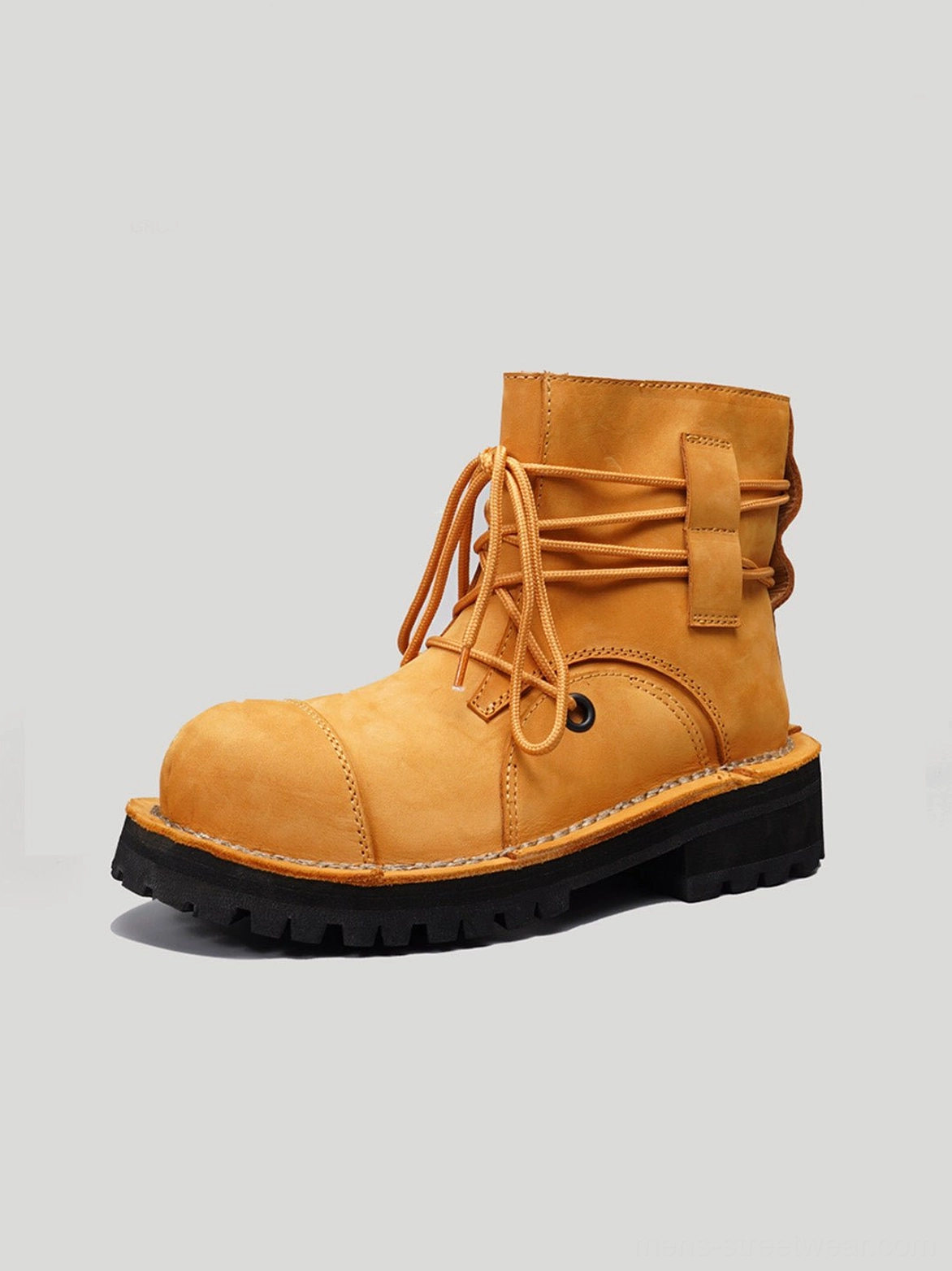 Yellow leather utility ankle boot front three-quarter detail showing lace-up closure rear cross-tie and lug sole