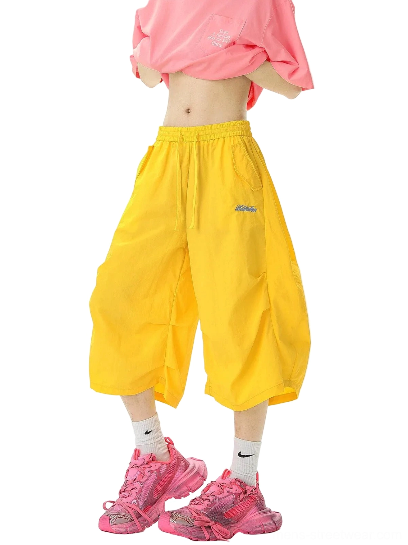 Front view of bright yellow oversized balloon cropped jogger shorts with blue embroidered logo and adjustable elastic drawstring waist