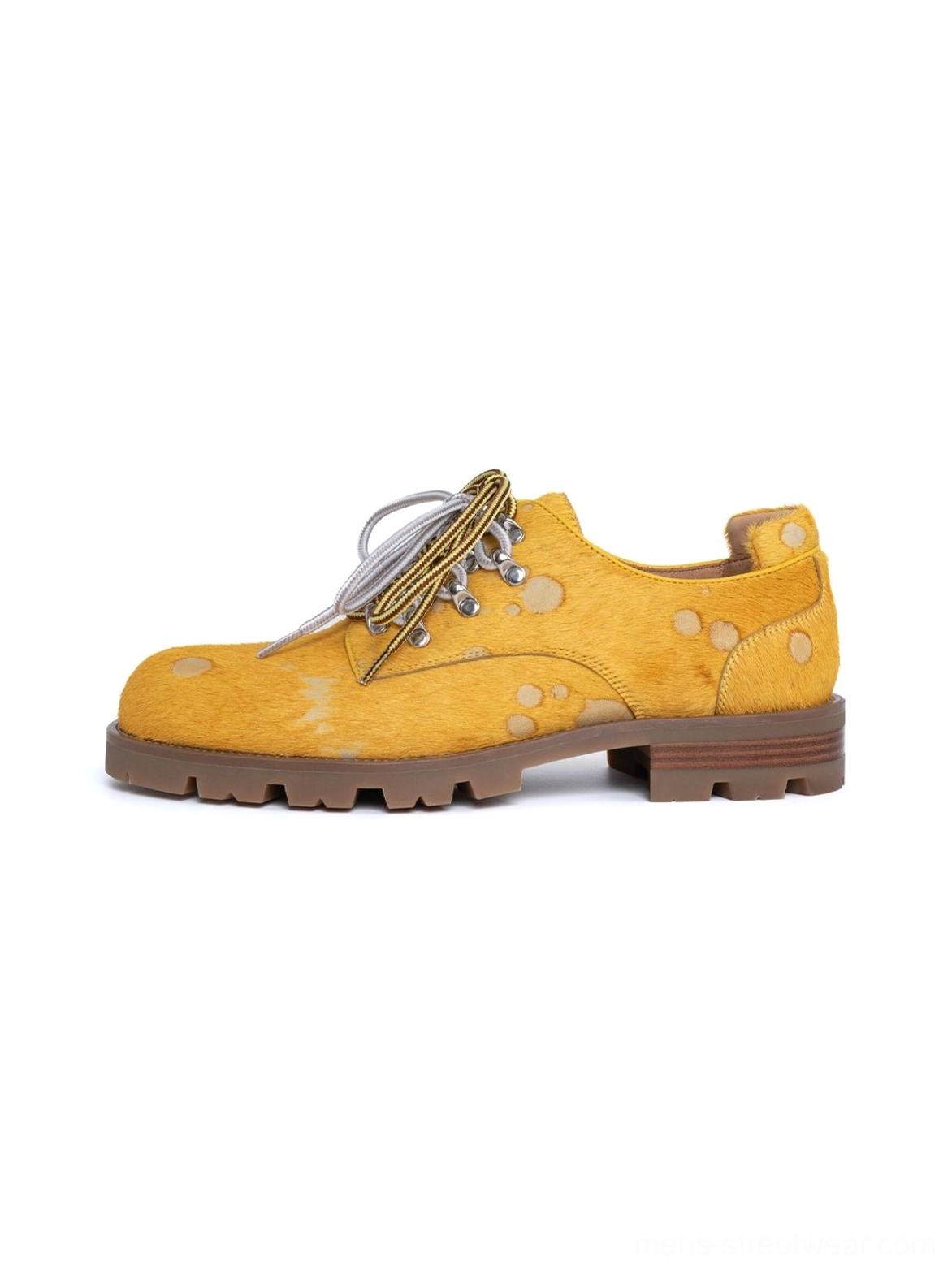 Mustard yellow spotted pony-hair leather derby shoes with two-tone laces and chunky rugged rubber outsole shown in a clean studio side profile
