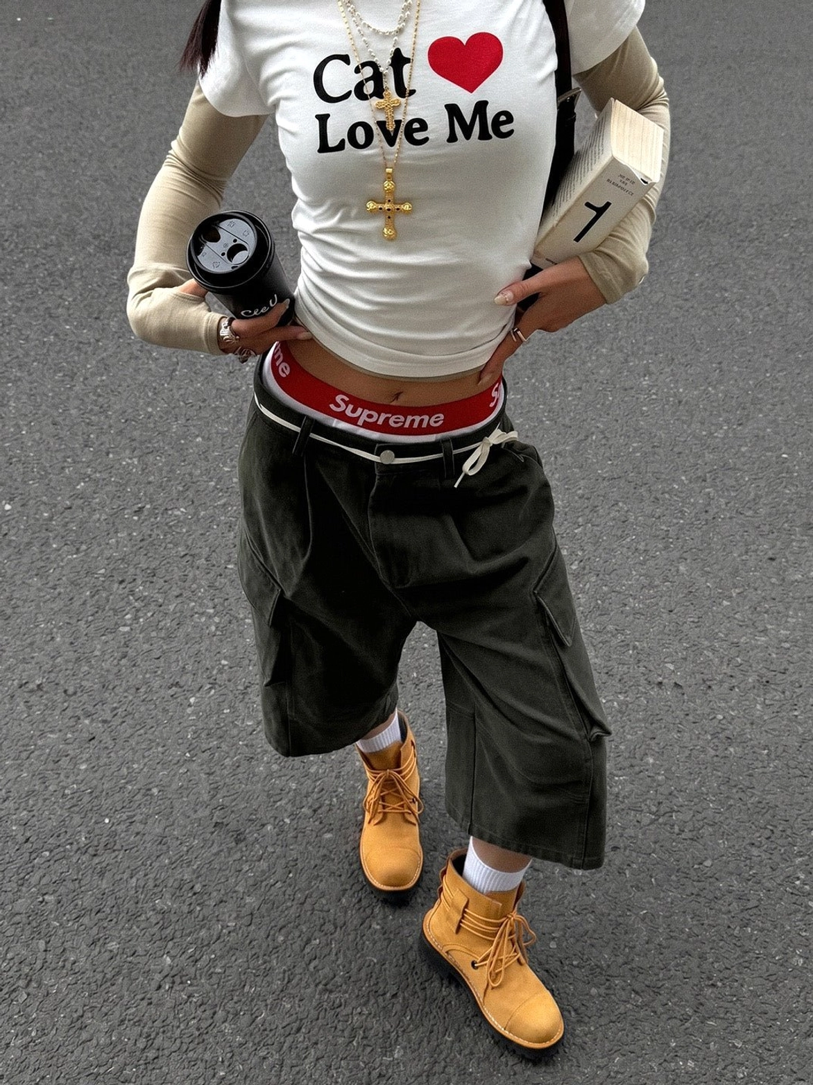 Female model wearing yellow two-tone leather utility ankle boots with cargo shorts in a streetwear outfit